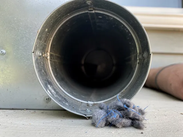 New London Dryer Vent Cleaning technician using specialized equipment to clear severe dryer vent blockage in New London